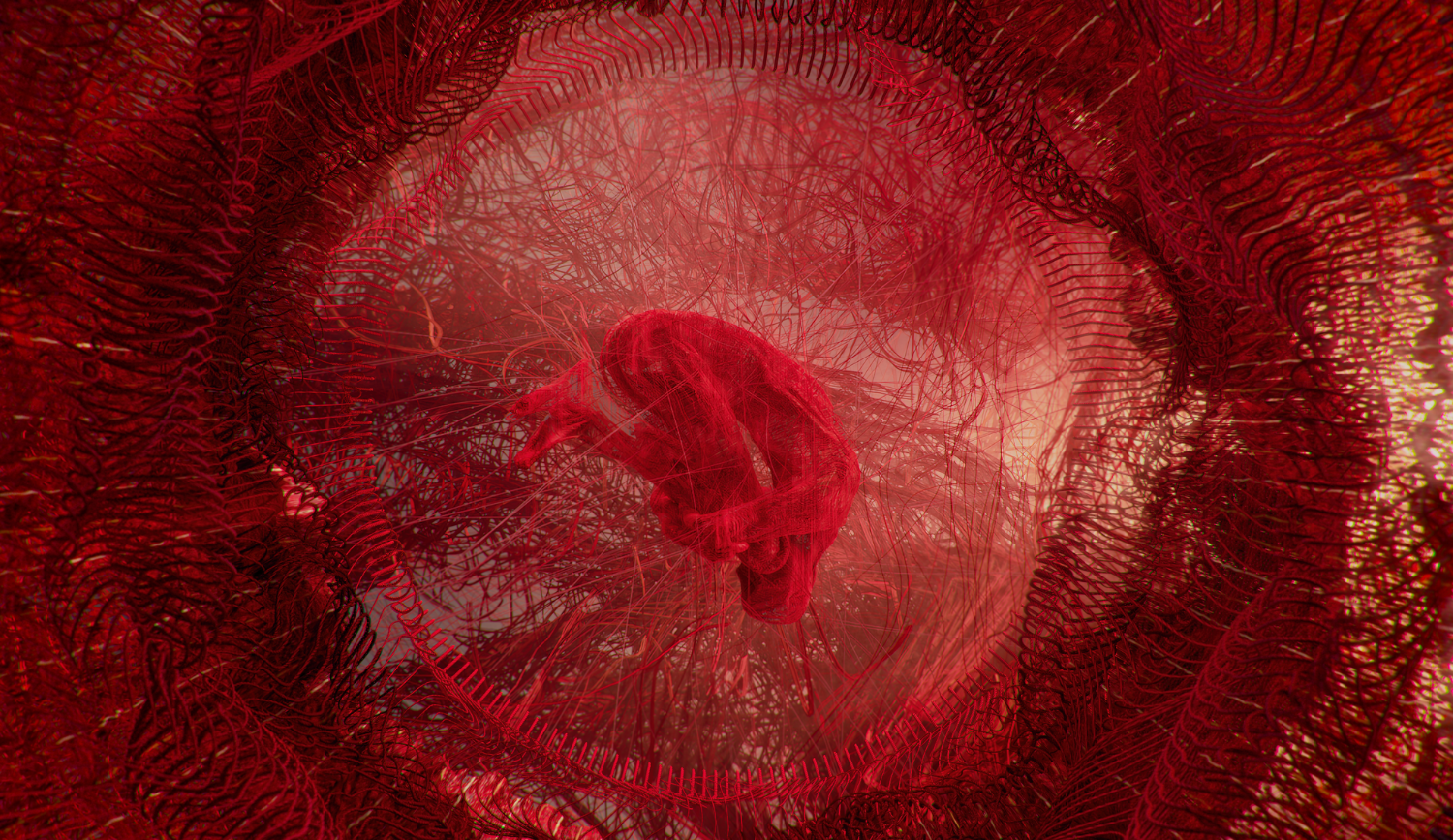 A video still showing a human figure entwined in red thread suspended in space.